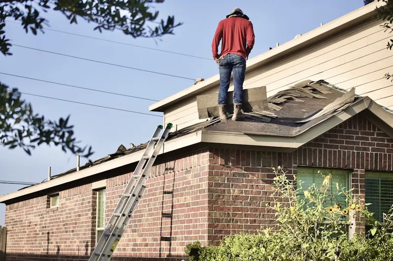 Professional roofer working on a residential roof in Sayre